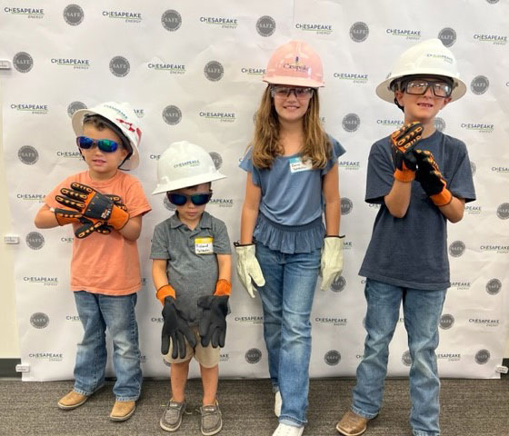 Annual Kids at Work Day - kids trying on hardhats and workwear